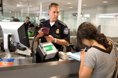 CBP Officer processes a passenger into the United States at an airport