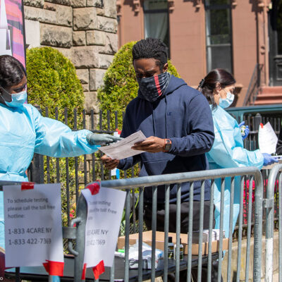 Medical personnel help residents sign up for a COVID-19 test outside of a church in Brooklyn, New York.