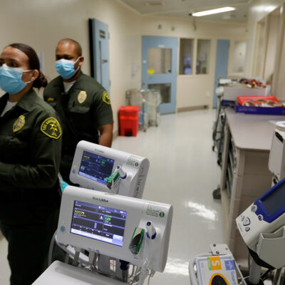 Custody assistants walking through hallway of the hospital ward in a jail in Los Angeles.