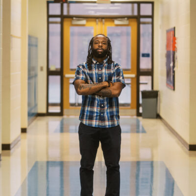 Anthony, a teacher profiled in this blog, stands in the middle of his school's hallway