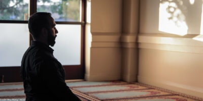 Ali Malik praying in a mosque