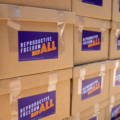 Stacked cardboard boxes that are marked "Reproductive Freedom For ALL" and contain signatures to put Proposal 3 on the ballot this November 2022, which would restore the protections of Roe v. Wade in the Michigan constitution.