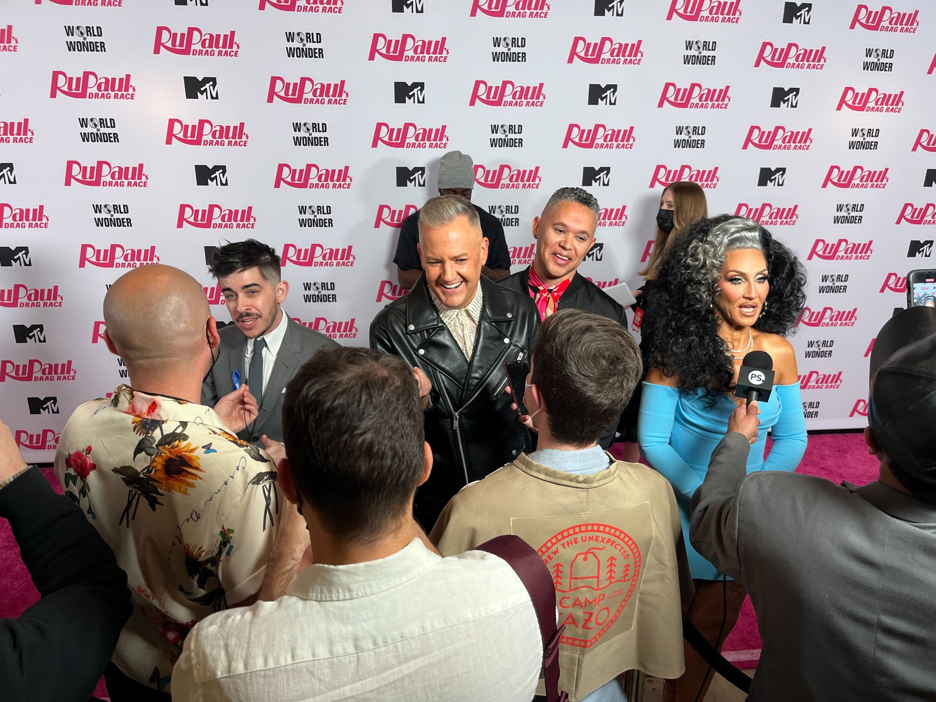 ACLU attorney Chase Strangio, and RuPaul's Drag Race judges Ross Matthews and Michelle Visage being interviewed on the red carpet for the season 15 finale.
