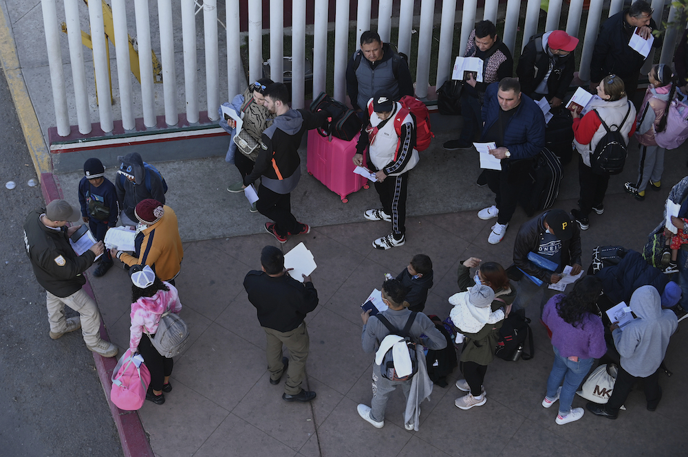Migrants form a line in Tijuana, Mexico.