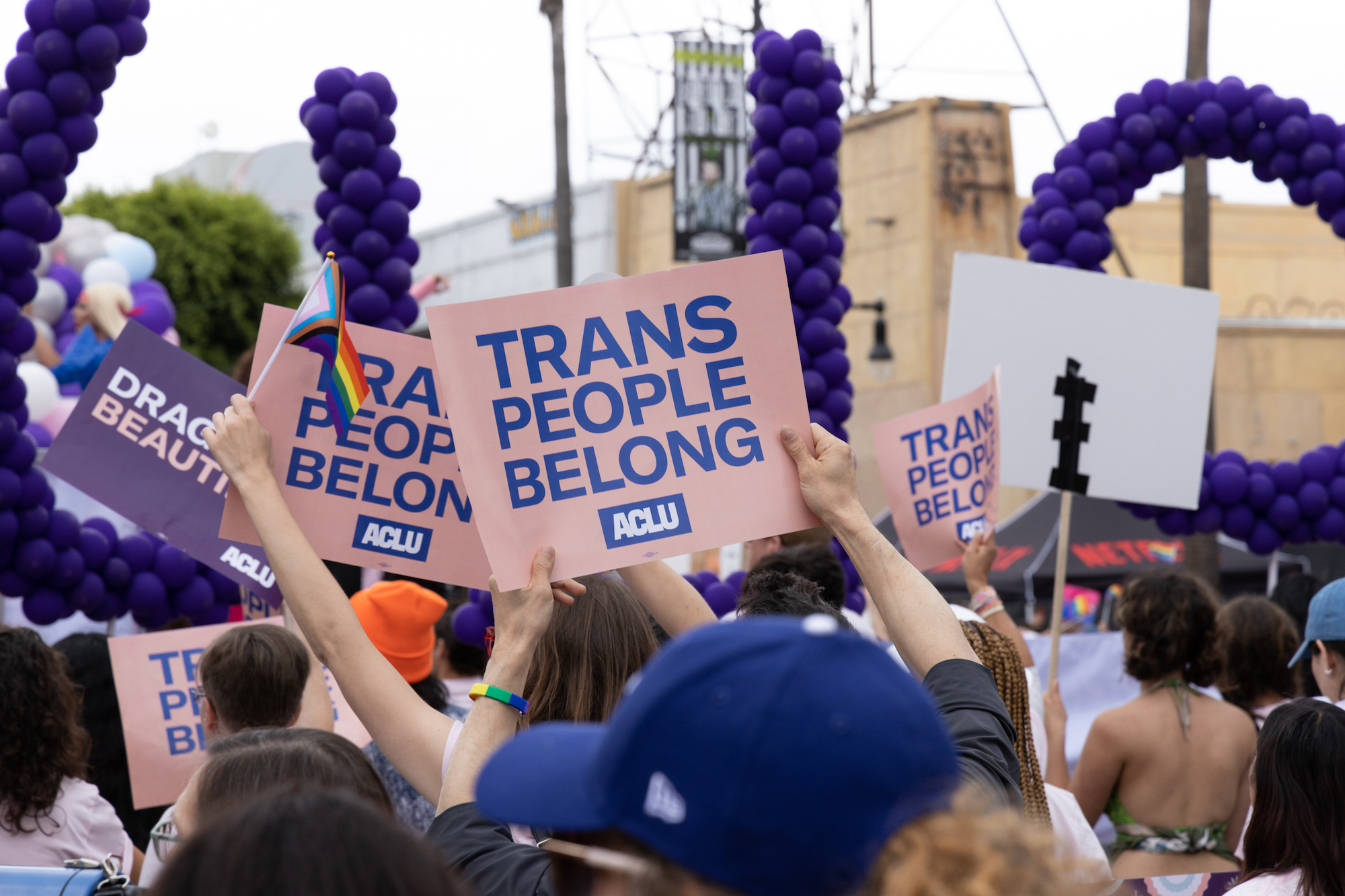 A group of individuals holding ACLU signs that says Trans People Belong.